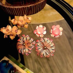 Three pairs of vintage pink clip on earrings one signed Star